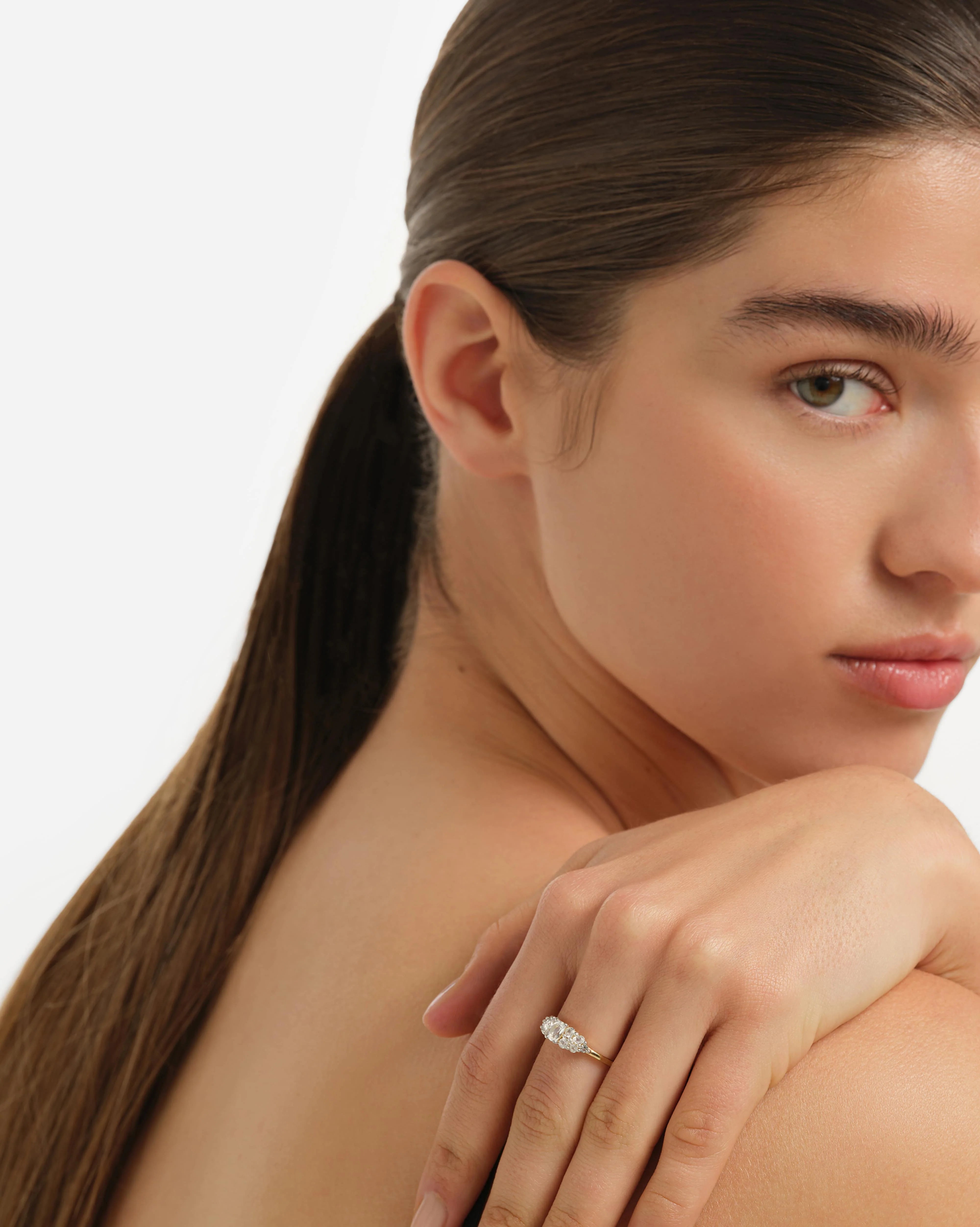 Woman wearing a diamond ring on a white background