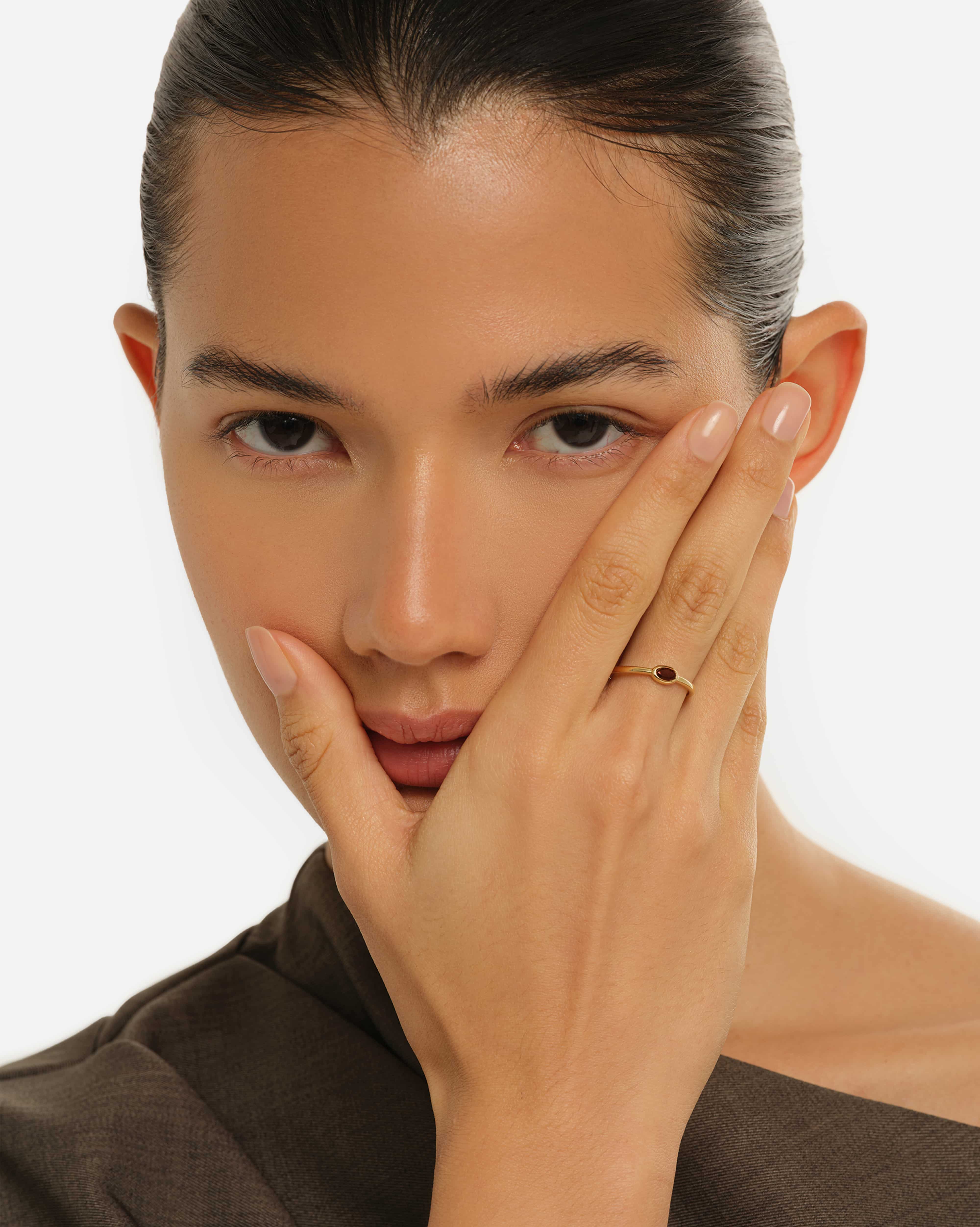 Model styling the Deep Red Natural Garnet Solitaire Ring by Handiora - Minimalist 18K Gold Vermeil Jewelry for Women